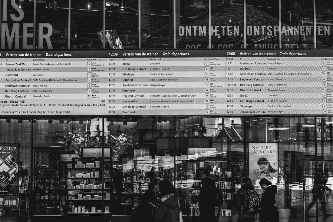 grayscale photo of people in front of store