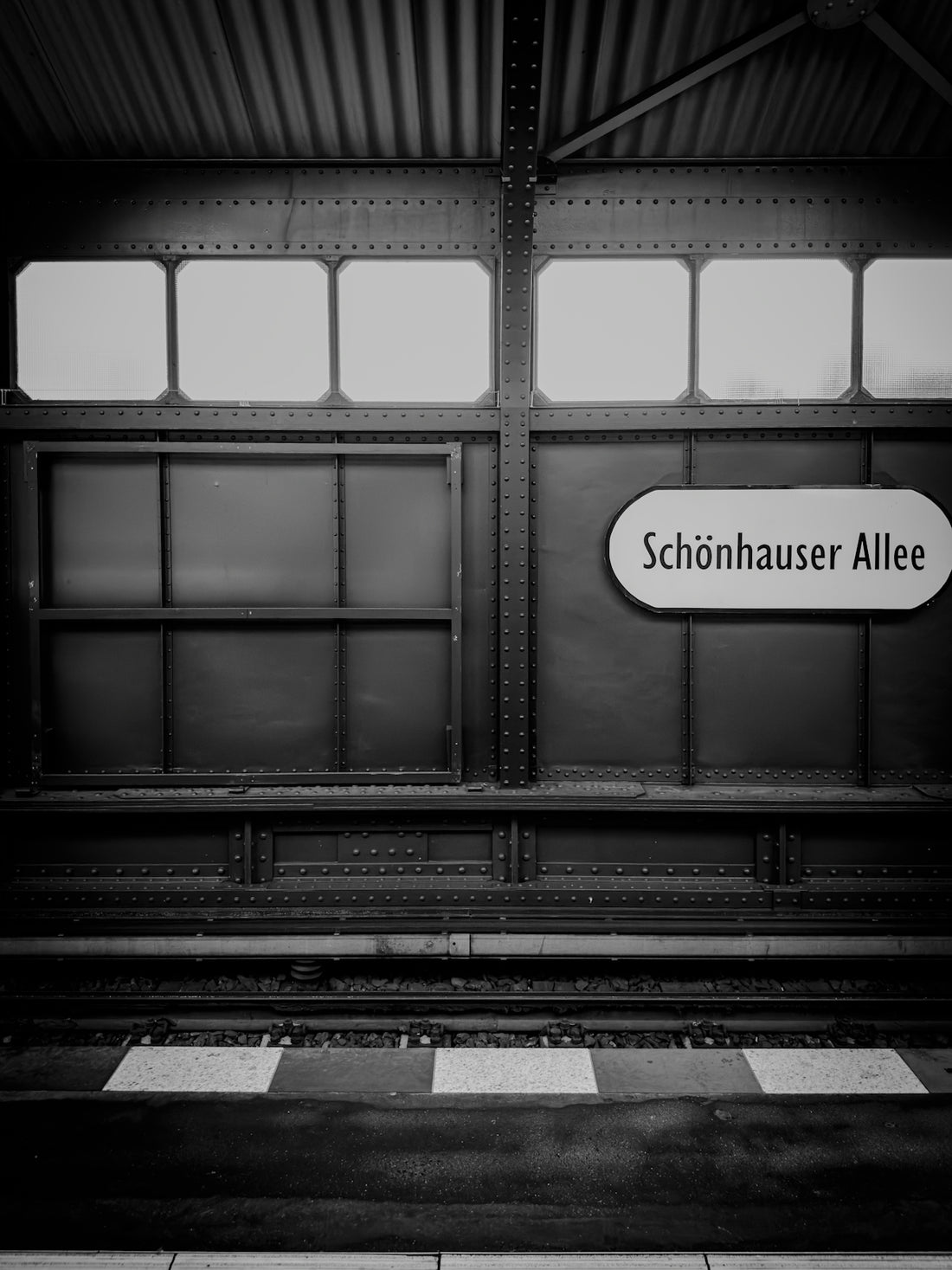 A black and white photo of a train station