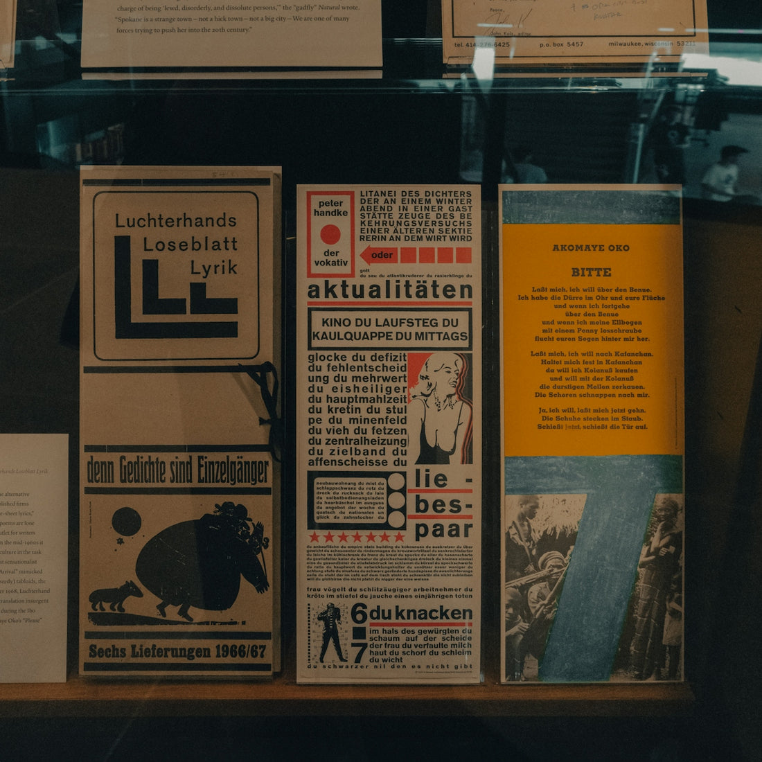 Three vintage german posters displayed in a museum